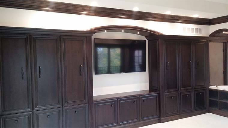 Master suite entertainment center during construction by Silent Rivers, chocolate stained custom cabinets, arched soffit with LED lighting