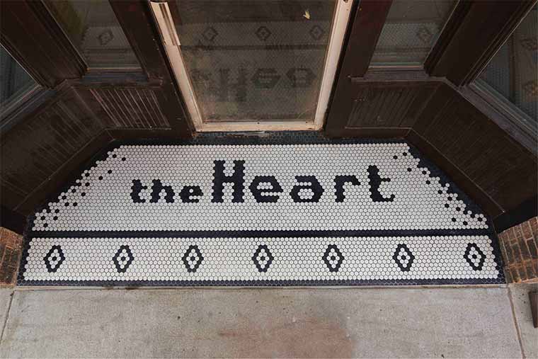 Tile entry to Healing Passages Birth Center with black and white octagon tile that says "theHeart", by Silent Rivers