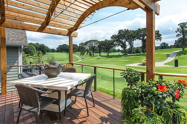 New deck designed and built by Silent Rivers, Des Moines, Iowa allows golf course views under curved arc pergola through bar and tie cable railing