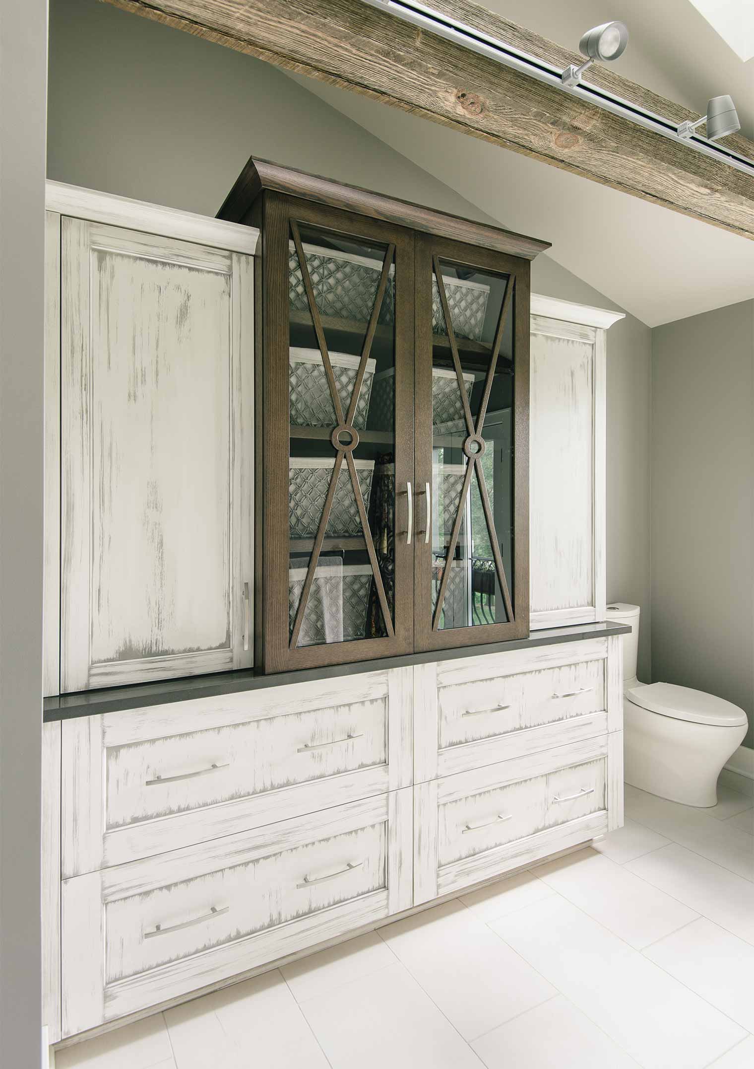 custom linen cabinet with white wash glaze and metal accents in contemporary bathroom by designer and remodeler Silent Rivers of Des Moines, Iowa