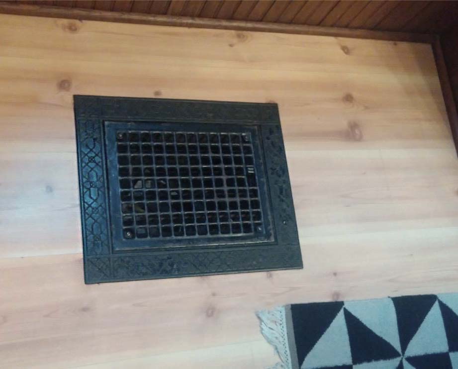 cast iron floor registers with ornate picture frame and grid work in Des Moines Victorian home being remodeled by kitchen remodeler and designer Silent Rivers Design+Build of Des Moines, Iowa