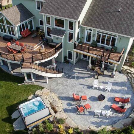 curved deck, patio, stairs, spa for resort style backyard by Silent Rivers of Des Moines