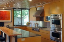 Contemporary style kitchen remodel of a 1970s home in Des Moines, Iowa by Silent Rivers Design+Build featuring custom cabinets