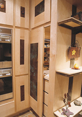 Maple wood cabinets with metal panels in a kitchen