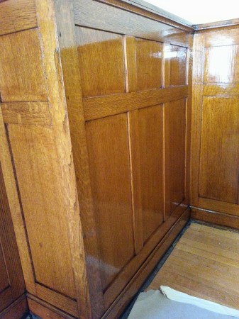 The high gloss shellac finish on this dining room wainscot restores the original "glow" of the quartersawn oak.
