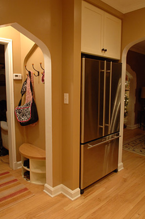 Framing was modified remove a pantry closet which allowed the refrigerator to be relocated and a niche & bench to be added.