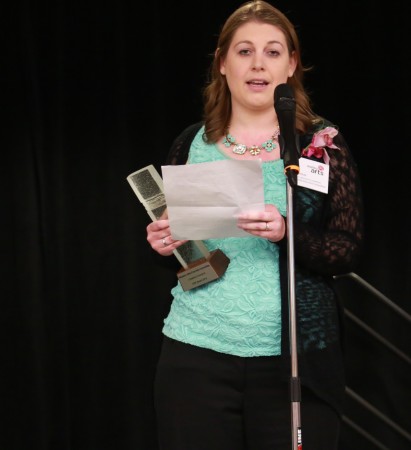 Lisa Thomas, chair of the fine arts committee, accepts the award.