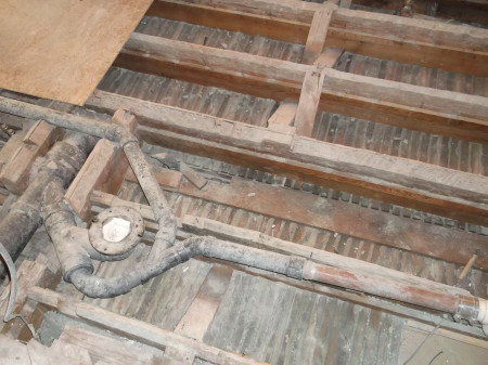 One of the surprises a remodeler doesn't like to find: plumbing cut through joists.