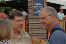 Stephen King, Executive Director of the Des Moines Arts Festival stops by Neymaster Law Firm gathering and visits with Mary Cownie.