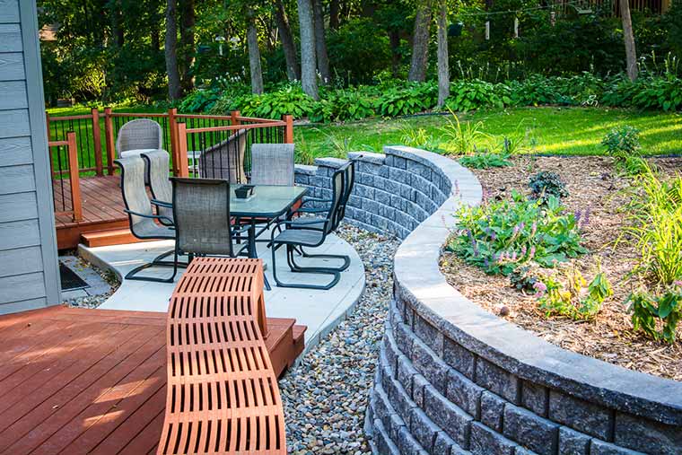 New patio, two adjoined decks and a curved retaining wall design