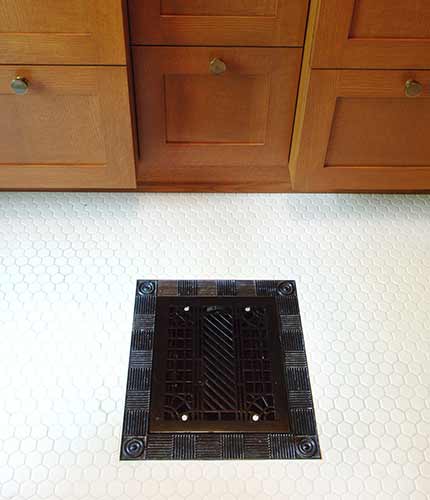 Cast iron floor grate in a Victorian bathroom remodeled by Silent Rivers
