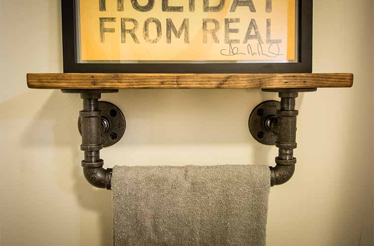 Towel bar made from gas pipe and electrical conduit in a downtown Des Moines loft bathroom remodel by Silent Rivers