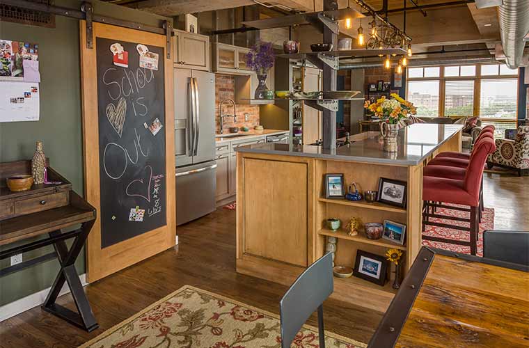 Downtown Des Moines loft kitchen remodel with custom cabinets and chalkboard barn door by Silent Rivers