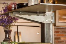Custom-made steel shelf in a downtown Des Moines loft remodeled by Silent Rivers