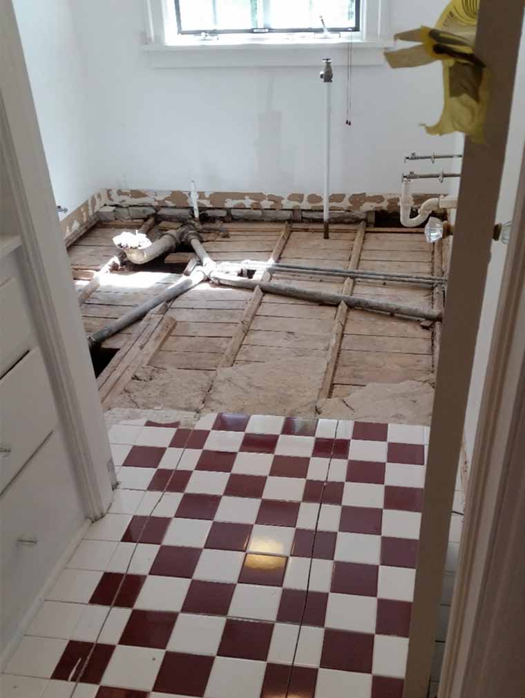 Old plumbing and electrical discovered during a remodel of a Des Moines Craftsman home bathroom