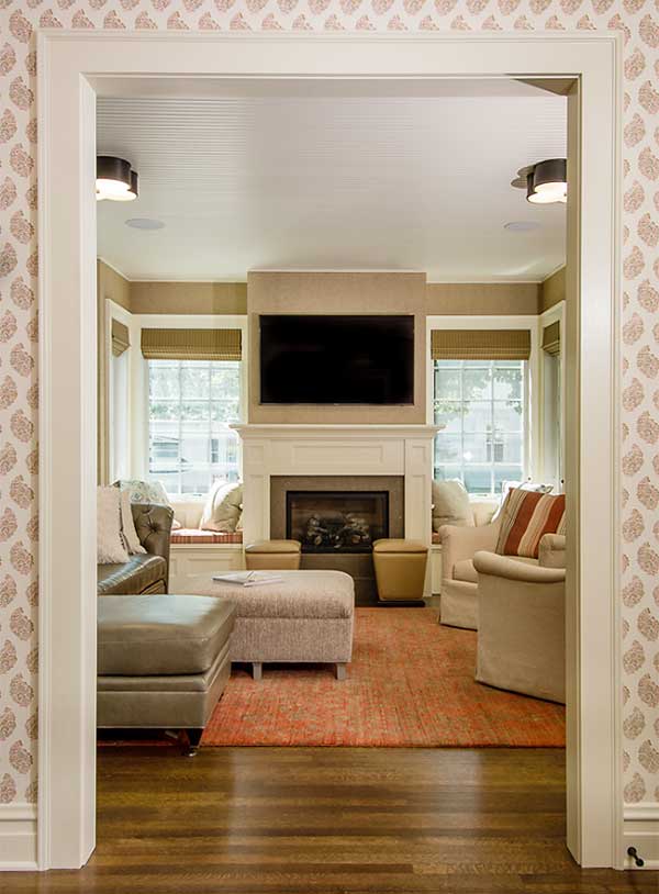 Sunroom family room addition for a 1900s farmhouse showing fireplace designed by Silent Rivers