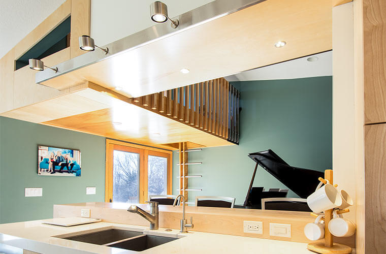 Johnston Iowa contemporary midcentury kitchen remodel by Silent Rivers, view of lofted playroom and adjacent music room