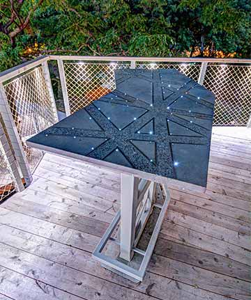 Table in elaborate treehouse inlaid with stainless steel and fiber optic lights custom designed by Silent Rivers for a Johnston, Iowa home