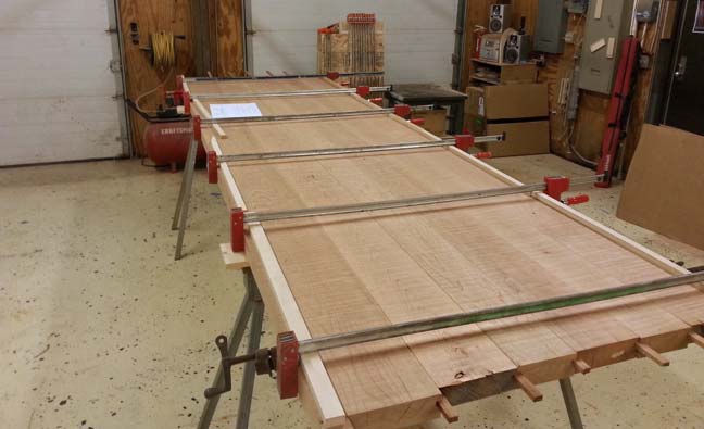 Cherry wood boards being glued together for large custom designed table for 12 by Silent Rivers
