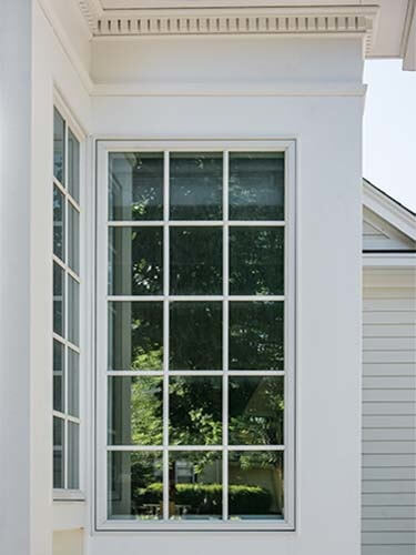 Exterior view of windows in the addition Silent Rivers designed and built onto an historical Des Moines colonial farmhouse shows how the trim matches the original.