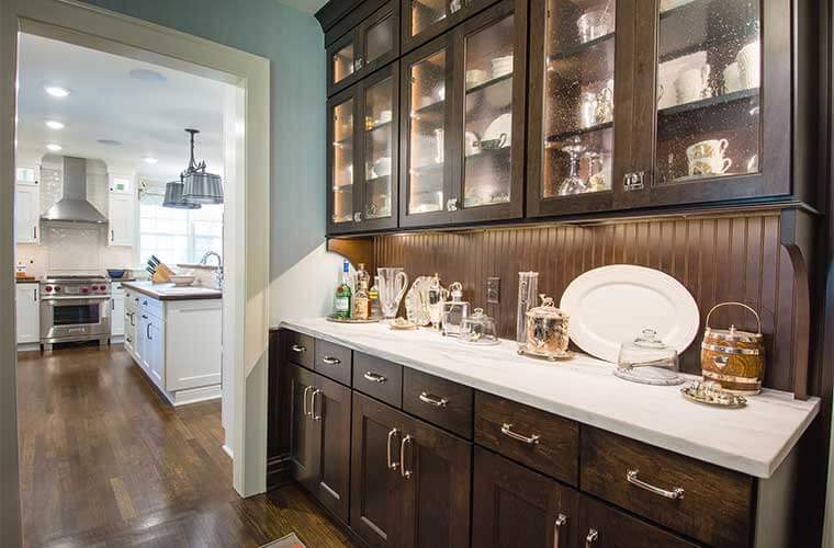 Butler's pantry adjacent to white kitchen designed by Silent Rivers in a historic Des Moines colonial farmhouse