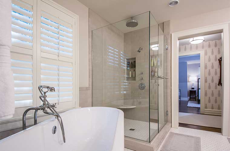 Master bathroom in an addition designed and built by Silent Rivers on a historic colonial style farmhouse features a glass shower enclosure and standalone bathtub.