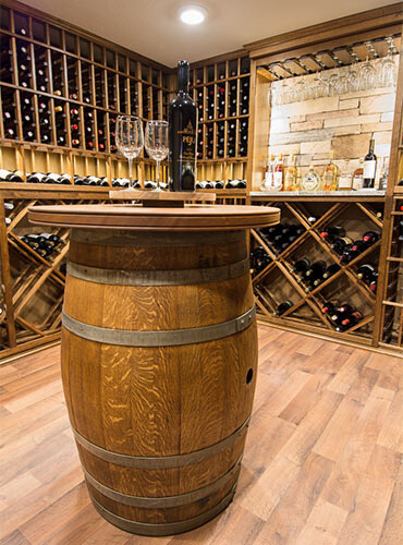 Wine cellar in Des Moines with oak wine barrel tasting table built by Silent Rivers