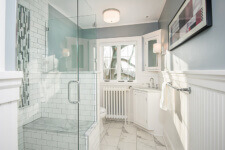 Des-Moines-craftsman-bathroom-by-Silent-Rivers with frameless glass shower surround and custom tile