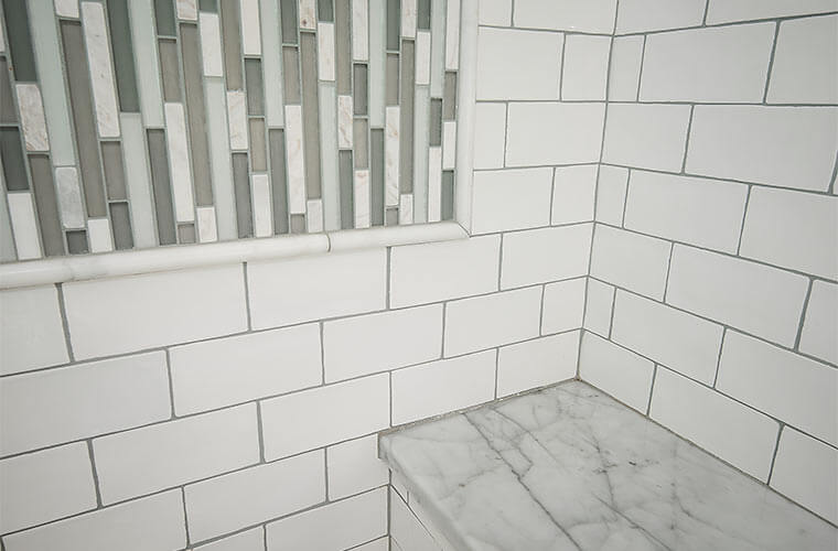 Des Moines, Iowa craftsman bathroom remodel by Silent Rivers uses glass tile and marble in the shower