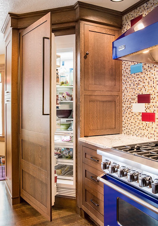 West Des Moines, Iowa craftsman kitchen remodel by Silent Rivers features custom paneled refrigerator door