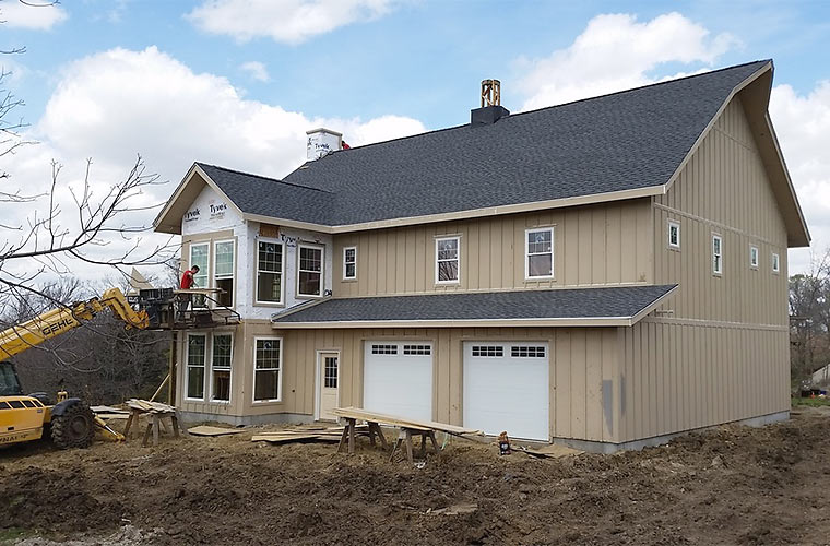 Installing windows and doors on a new house by Iowa homebuilders Silent Rivers Design+Build