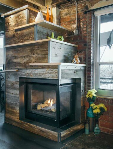 gas fireplace with barn board, raw steel, birch shelves in downtown Des Moines loft by Silent Rivers Design+Build