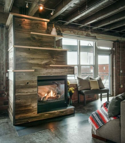 gas fireplace with barn board, raw steel, birch shelves in downtown Des Moines loft by Silent Rivers Design+Build