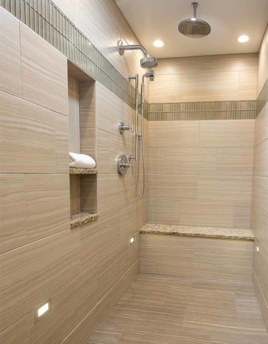 1980s bathroom remodel by Silent Rivers, Des Moines features oversized, zero entrance shower with a rain shower, a linear floor drain and LED lights low on the wall