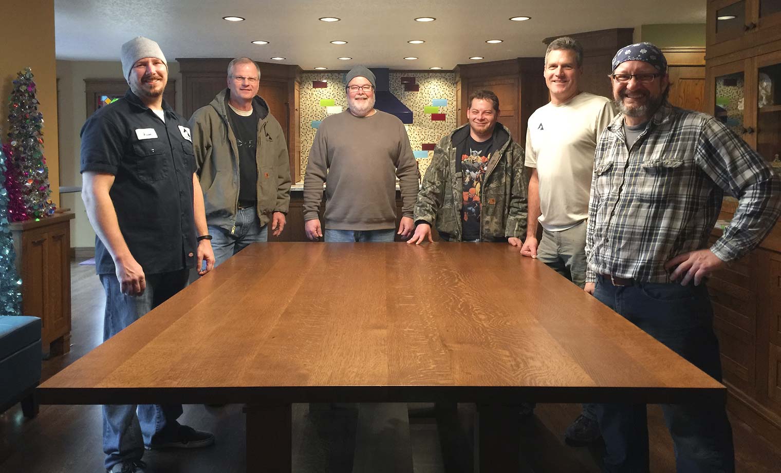 Silent Rivers artisans install the custom dining room table they built for a client who wanted to surprise his wife.