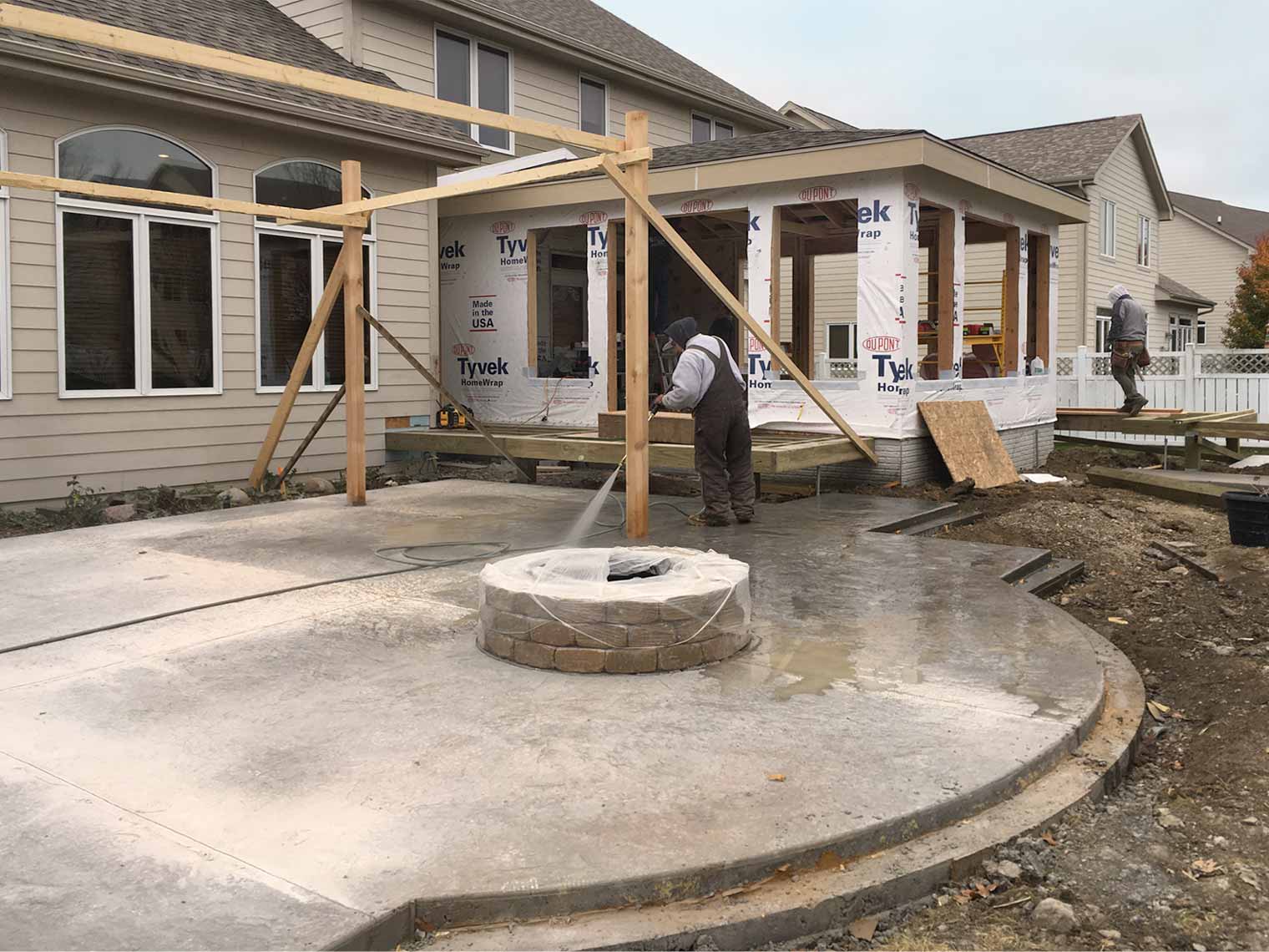 during construction of sunroom addition, new patio, fire pit and pergola designed and being built by Silent Rivers of Des Moines, Iowa