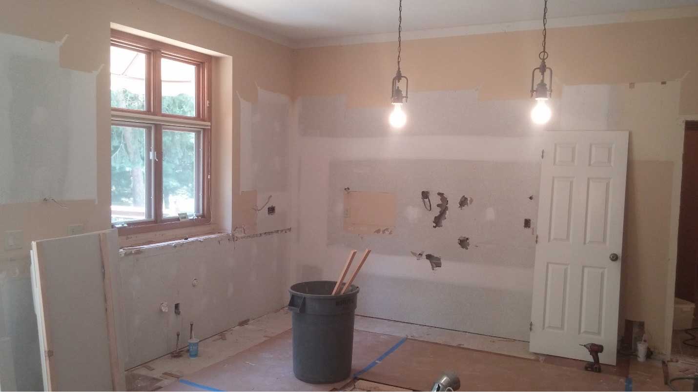 Kitchen remodeling during construction by Silent Rivers of Des Moines. Cabinets and appliances have been stripped.