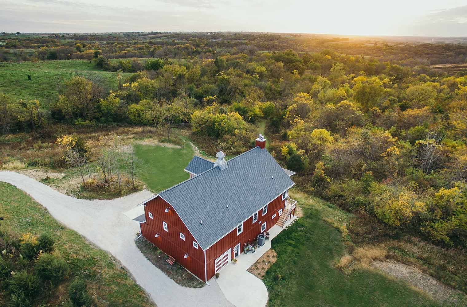 Custom new home by Silent Rivers of Des Moines is a barn style home in rural St. Charles, Iowa with scenic views of trees, open land and pastures