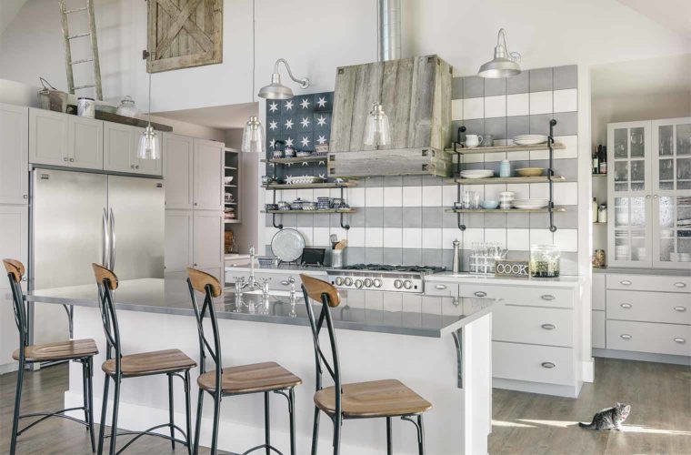 White kitchen of barn style custom new home in St. Charles, Iowa features artistic flag tile, farmhouse sink and faucet, reclaimed barn wood vent cover, designed and built by Silent Rivers, Des Moines