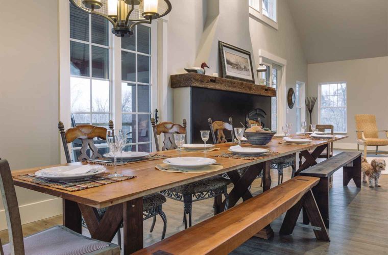 farmhouse industrial style custom dining room table opens to 12 feet long in barn style custom new home designed and built by Silent Rivers in St. Charles, Iowa