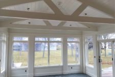sunroom addition in Des Moines designed and being built by Silent Rivers is in progress, framing complete and walls painted Dover White with blue slate tile floors ready to be grouted