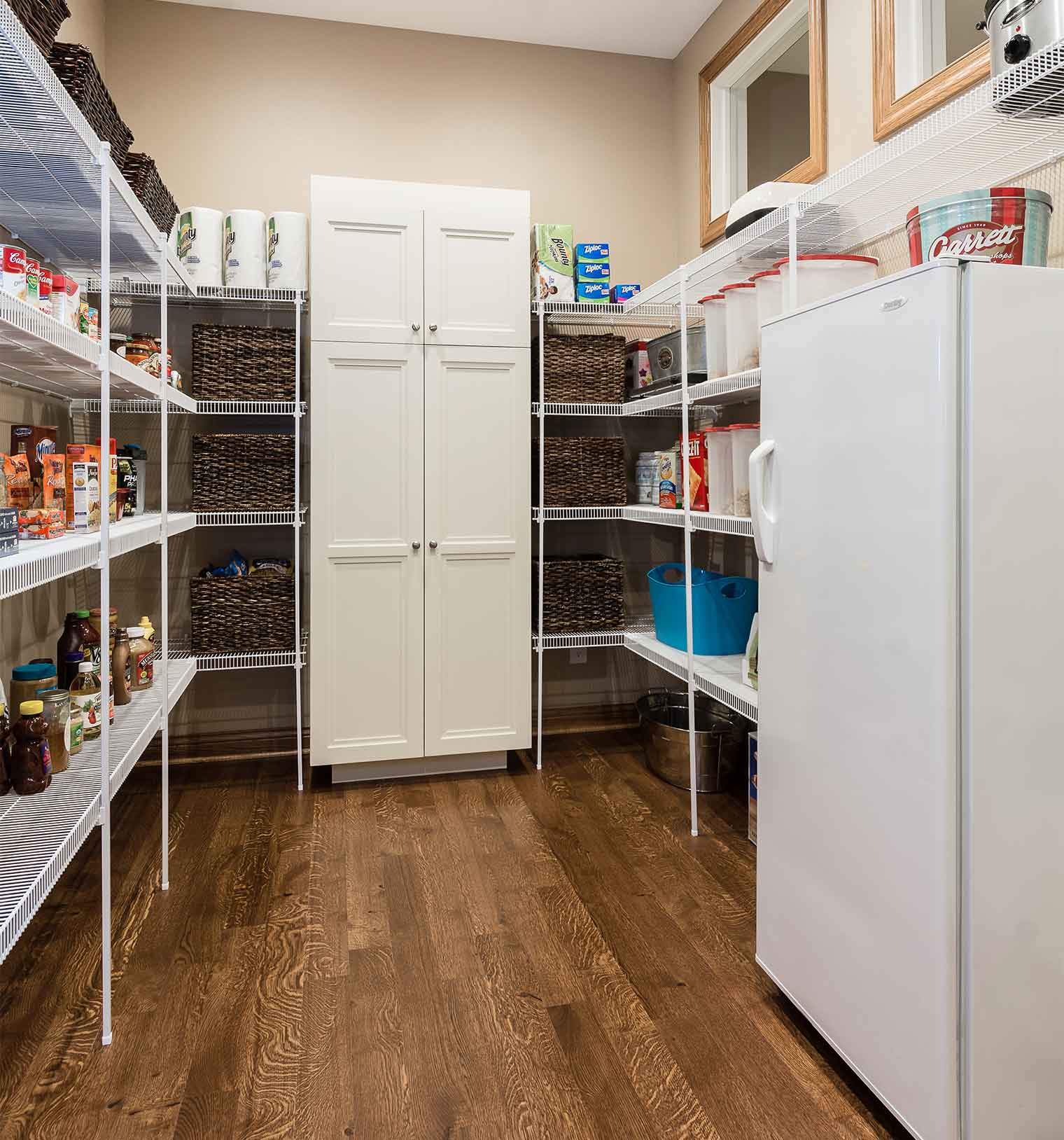 Pantry includes fridge and many shelves to organize specific food zones of organize this family of six in Clive, Iowa. Designed and built by Silent Rivers