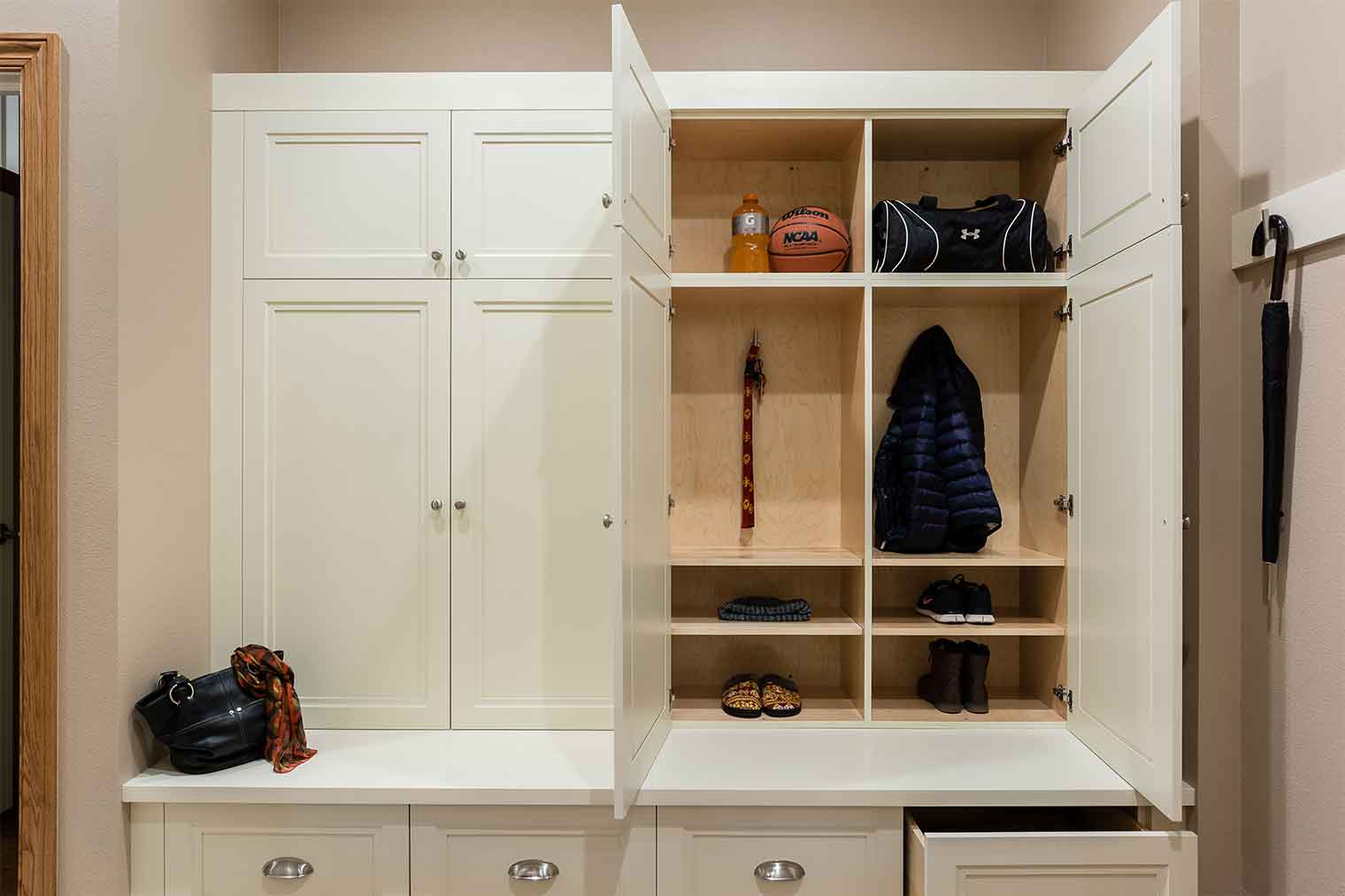 Mudroom remodel by Silent Rivers in this large Clive, Iowa features custom cabinets to organize this family of six