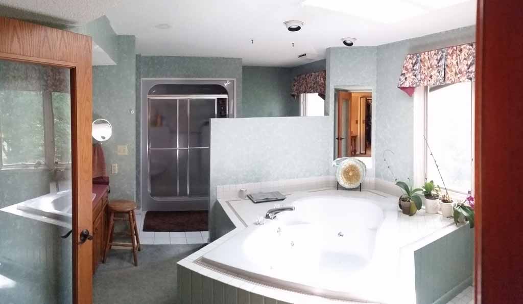 Before photo of original Jacuzzi tub that takes up too much space in this master bathroom being designed and remodeled by Silent Rivers of Des Moines
