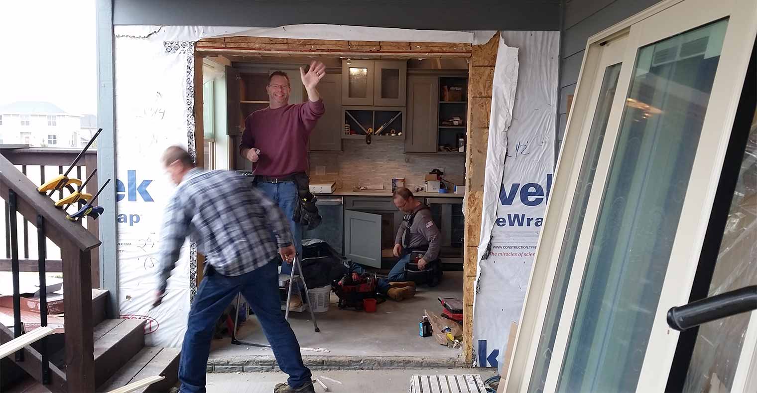 John Miller of Silent Rivers helps install new patio doors on an Urbandale, Iowa home being remodeled by Silent Rivers