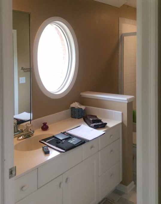 before photo of 3/4 bathroom with round window to be redesigned by Silent Rivers, Des Moines, Iowa