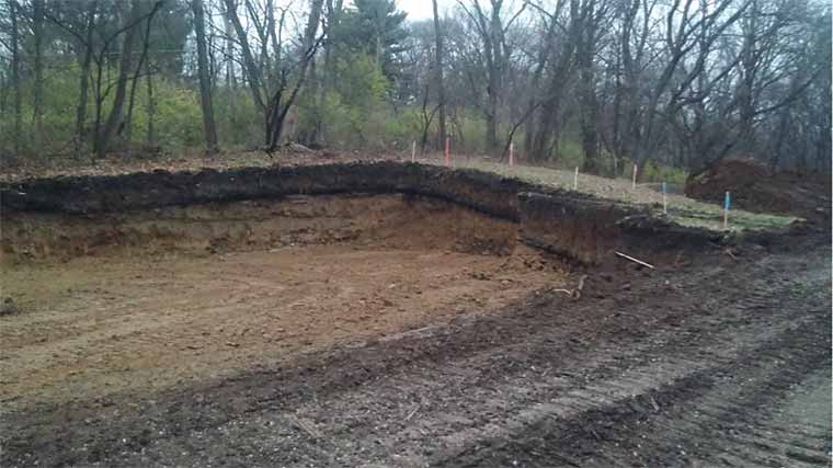 Excavated Des Moines lot prior to footings for a custom new home designed and built by Silent Rivers
