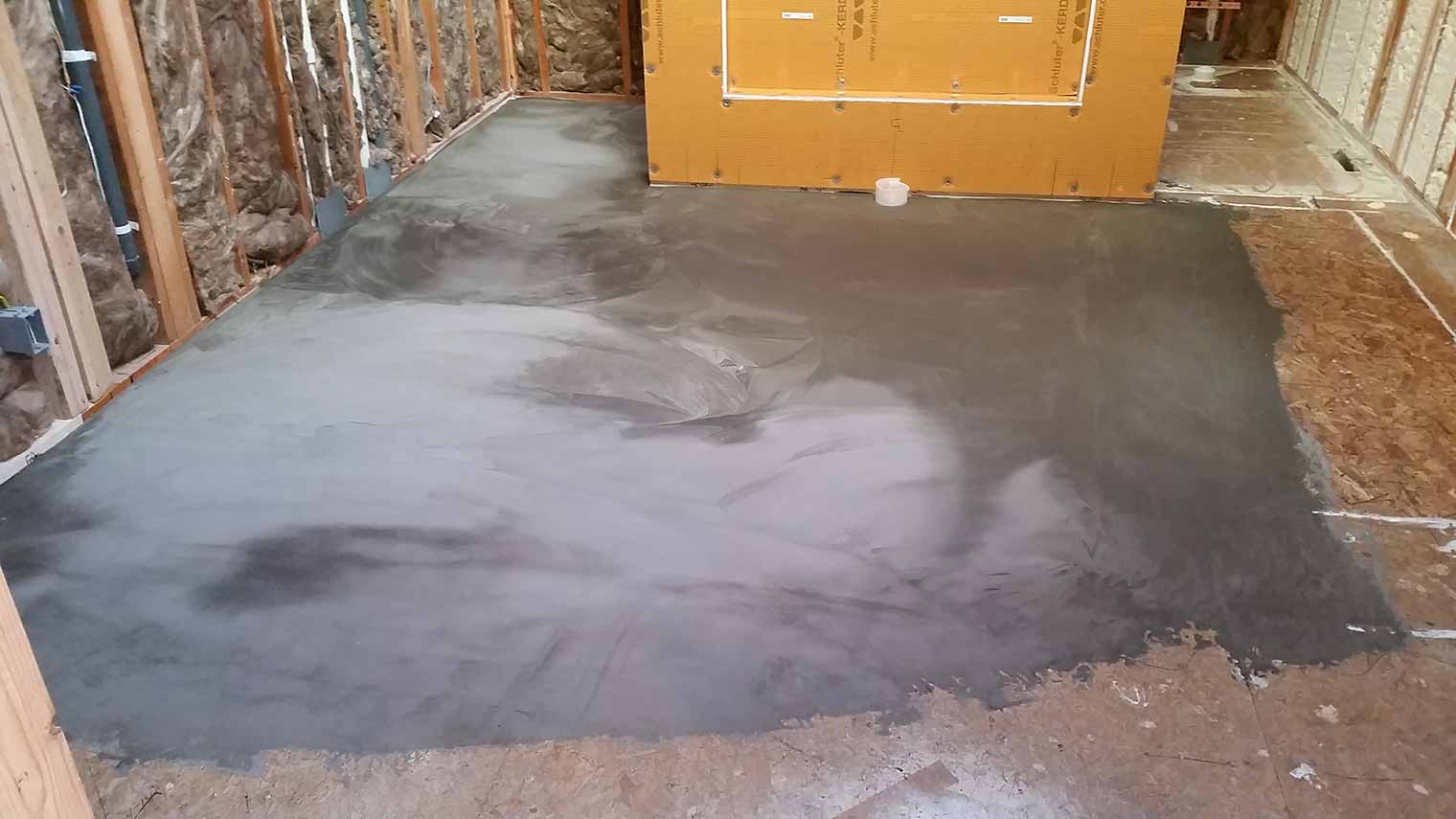 Floor leveler is poured onto the bathroom subfloor to even out the floor in this master bathroom remodel in Granger, Iowa by Silent Rivers