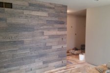 Wood clad accent wall is installed in a master suite remodel in Granger, Iowa designed and built by Silent Rivers