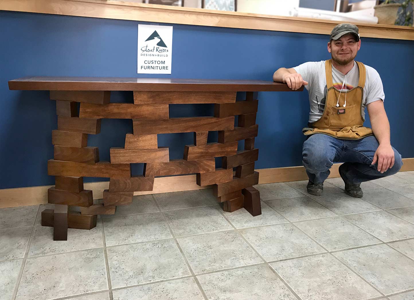 Alex Schlepphorst from the Silent Rivers Design+Build Woodshop and Woodworking Team in Des Moines, Iowa created this custom furniture console table out of scrap blocks of wood along with Tom Bloxham